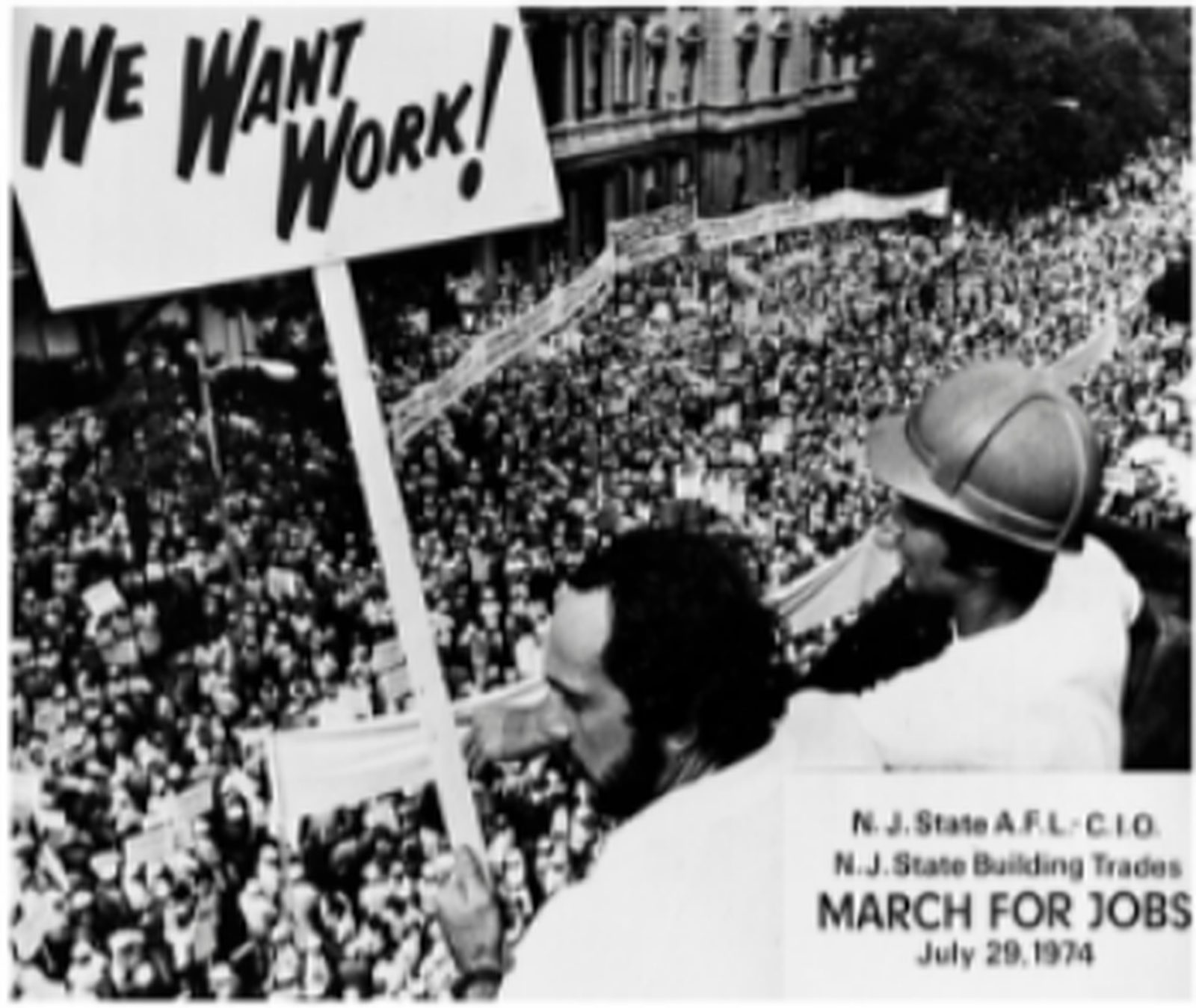 Black-and-white photo of the 1974 March for Jobs, with a sign reading We Want Work